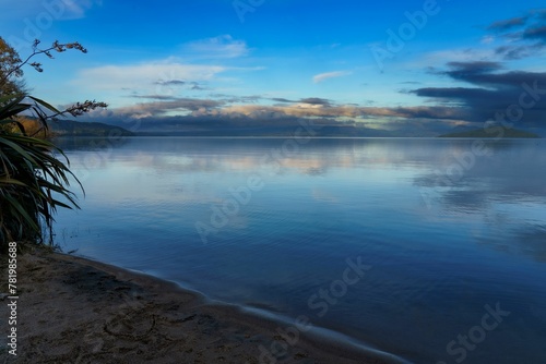 Beautiful shot of clouds reflected on Lake Rotorua in New Zealand during the sunset