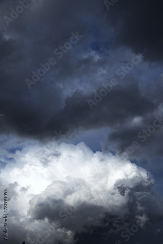 dramatic sky with contrasting cloud formations, ominous storm clouds. concepts: book cover for novels with themes related to storms, suspense or change, weather forecasting websites or apps