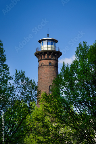 Wallpaper Mural the historic helios lighthouse behind trees and against a blue sky Torontodigital.ca