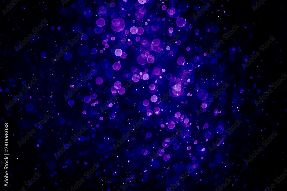 Blurred photo with purple violet and blue dots visible glittering, shining brightly look and feel luxurious