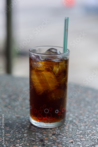 Cola with crushed ice and a straw in a clear glass is ready to drink to quench your thirsty