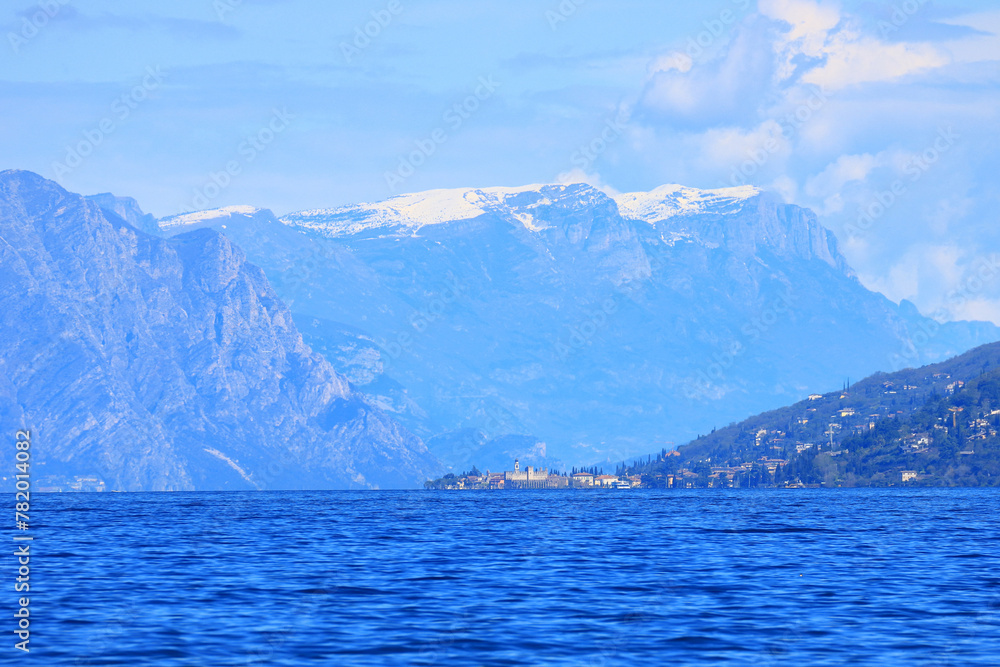 Lago di Garda, view to the lake and Alps covered with snow in background, Italy