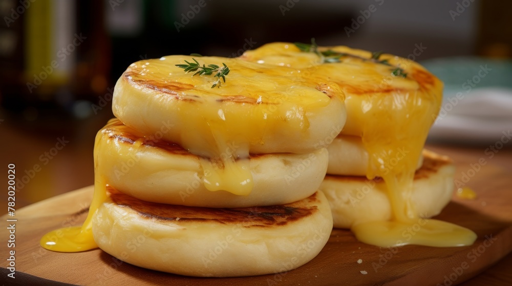 Stack of English muffins topped with melted cheese Stack of English muffins topped with melted cheese