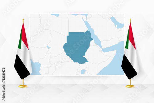 Map of Sudan and flags of Sudan on flag stand.