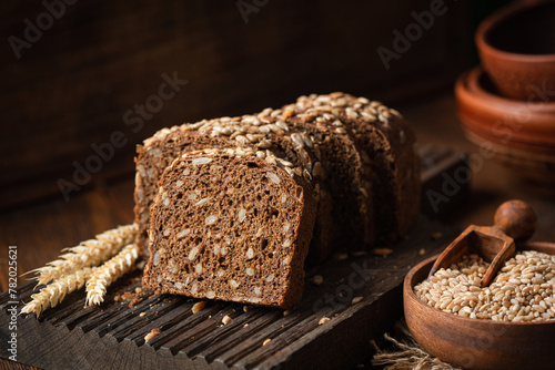 Rye bread with sunflower seeds on a wooden cutting board, closeup view