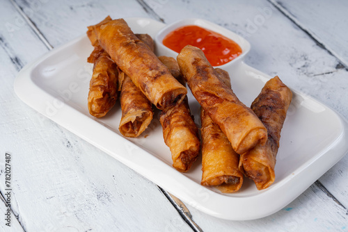 Filipino most favorite food, ground marinated pork meat wrapped in rice wrapper and serve with sweet and sour sauce, also known as lumpiang shanghai
