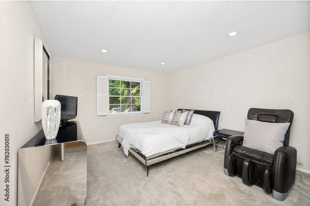 Fototapeta premium Interior shot of a room featuring a television, bed, and chair in Encino, CA