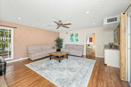 Room with hardwood floors, beige walls, and a carpet in Encino, CA