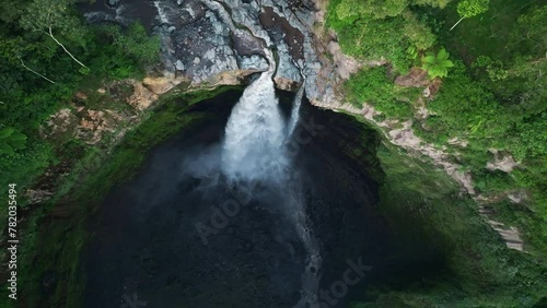Aerial drone flying back and tilt revealing Coban Sriti waterfall, Indonesia photo