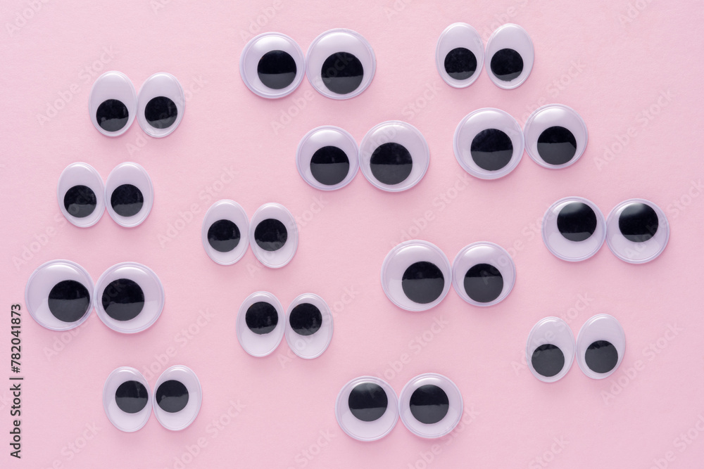 Creative layout of many googly eyes on pink background. Minimal concept. Creative layout of many googly eyes on pink background. Minimal concept.
