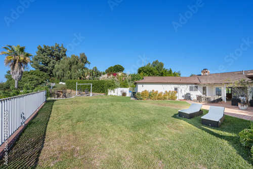 Grassy lawn with lush green grass and enclosed fencing in Hidden Hills, CA © Wirestock
