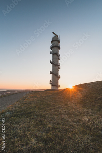 Radar Ossenisse under the sunrise rays in the south of the Netherlands. Security tower for the protection of the Holland