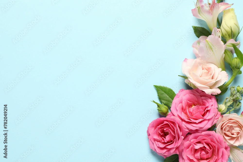 Happy Mother's Day. Beautiful flowers on light blue background, flat lay. Space for text