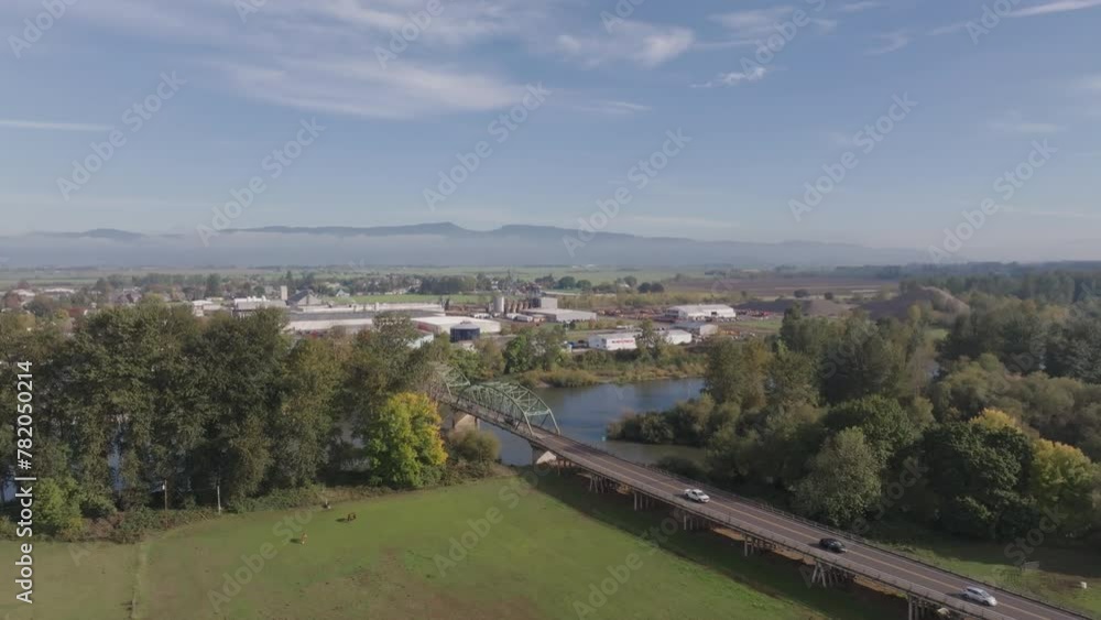 Aerial drone shot of small neighborhood town in Oregon with green hills, mountains, and clouds. Aerial drone shot of small neighborhood town in Oregon with green hills, mountains, and clouds.