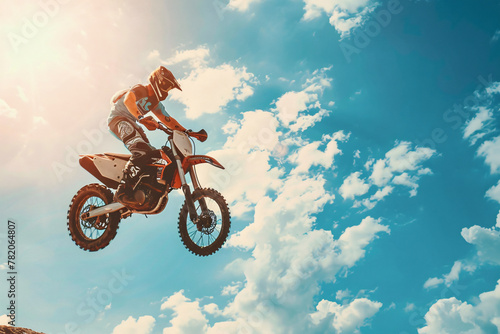 Motobike soaring with blue sky and clouds background