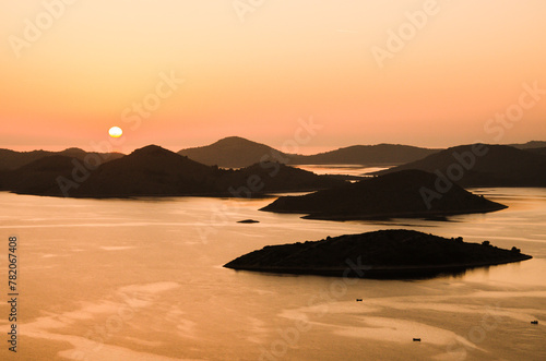 Beautiful sunset over the famous Kornati national park in Croatia, Europe, view from the top of the Zut island, sailboats on the sea photo