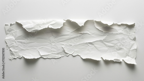 A single piece of torn white paper isolated on white background.