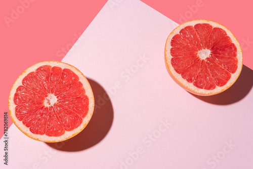 Creative fruit composition on pink background with hard shadows. Summer minimal concept.