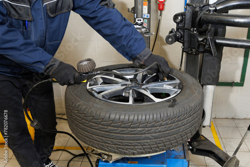 Car maintenance and service center. Vehicle tire repair and replacement equipment. Seasonal tire change