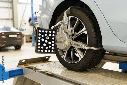 Car wheel alignment in progress at auto repair service centre