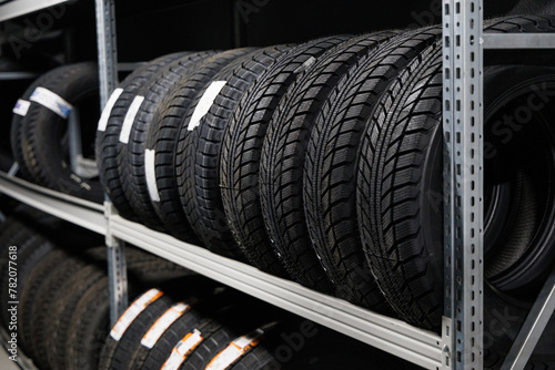 Car tires and wheels at warehouse in tire store