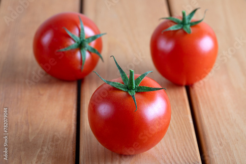 A group of tomatoes on a wooden floor,closeup
