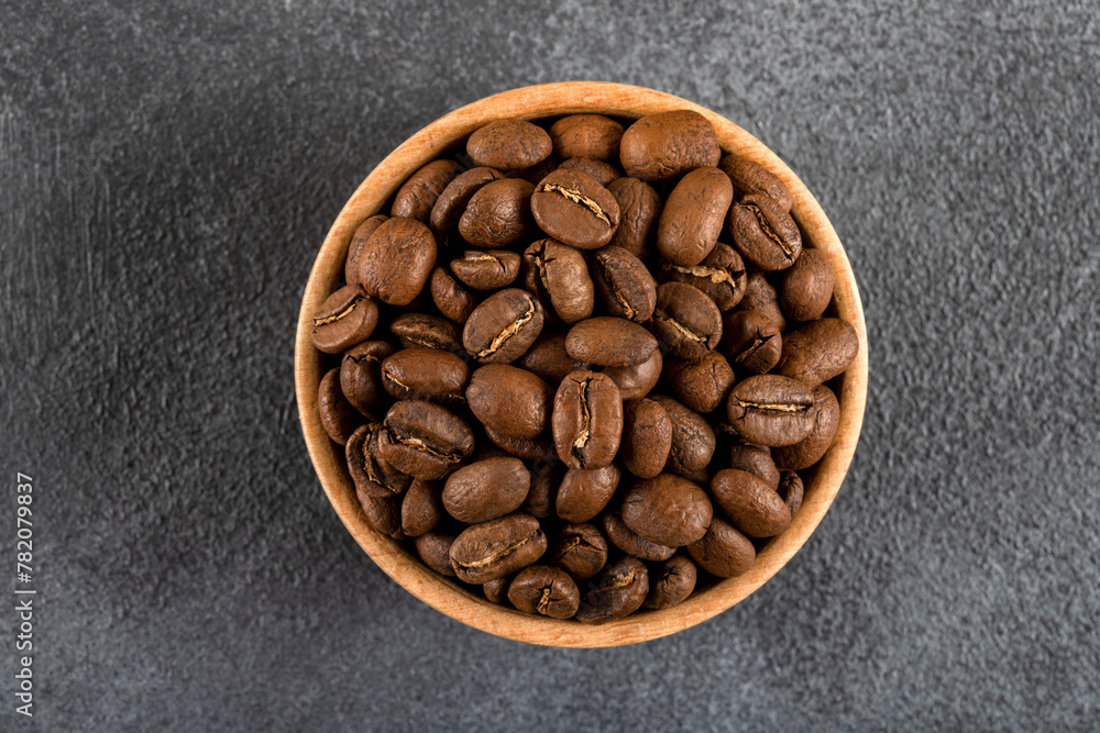 Fototapeta premium A bowl full of roasted coffee beans,top view