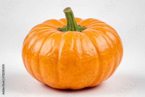 Bright orange pumpkin with green stem on white background. Perfect fall or Halloween themes