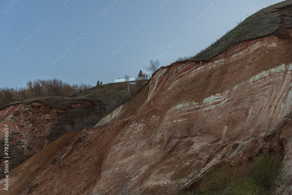 Fototapeta premium Stony pebble and clay banks of the Volga River. Mountain slope of various stone rocks. Tetyushi, Tatarstan.