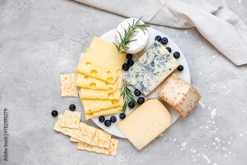 Cheese platter with craft cheese assortment  hard cheeses, mold cheese, gorgonzola, pecorino, Emmental, Roquefort photo