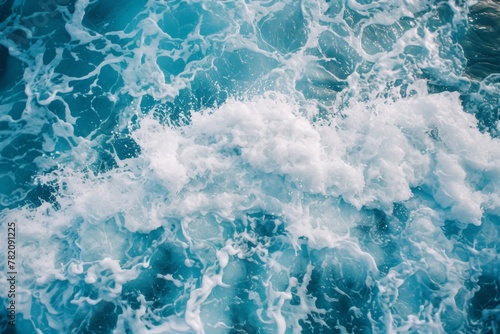 a close up of a body of water with waves and foam coming out of it