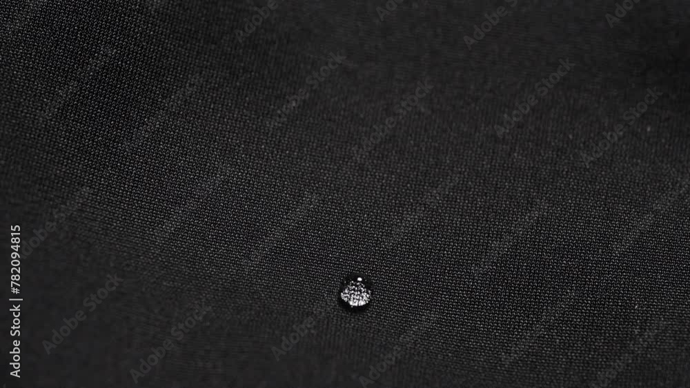 Water drops on waterproof black fabric. Water drops on waterproof black fabric.