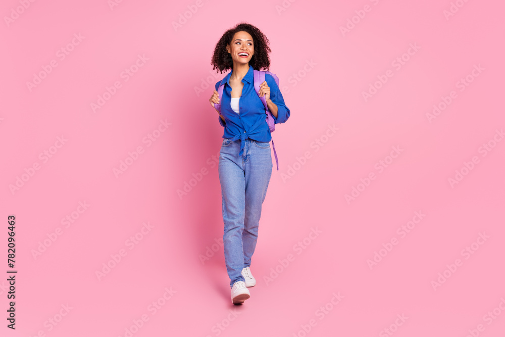 Photo of charming lovely girl wear stylish blue clothes go college look empty space isolated on pink color background Photo of charming lovely girl wear stylish blue clothes go college look empty space isolated on pink color background