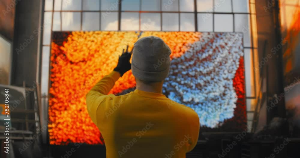 A Man In A Yellow Shirt Is Painting A Virtual Screen With Orange And Blue Colors Science Museum Video Art Motion Graphics A Man In A Yellow Shirt Is Painting A Virtual Screen With Orange And Blue Colors Science Museum Video Art Motion Graphics