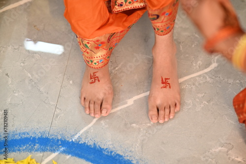 Hindu Swastik on legs. a Swastik As Symbol Of Sun. Hindu Religion. Red ink. Hinduism symbols