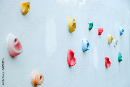 Colorful climbing holds on wall for outdoor rock climbing