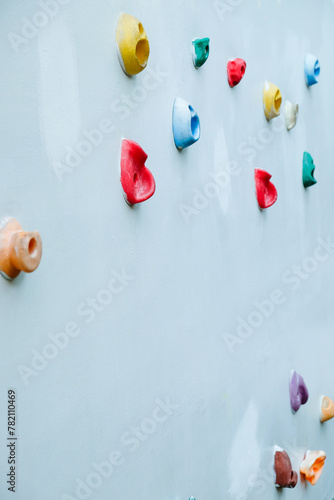 Colorful climbing holds on wall for outdoor rock climbing