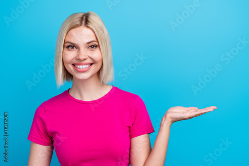 Wallpaper Mural Photo portrait of lovely young lady palms hold empty space dressed stylish pink clothes isolated on blue color background Torontodigital.ca