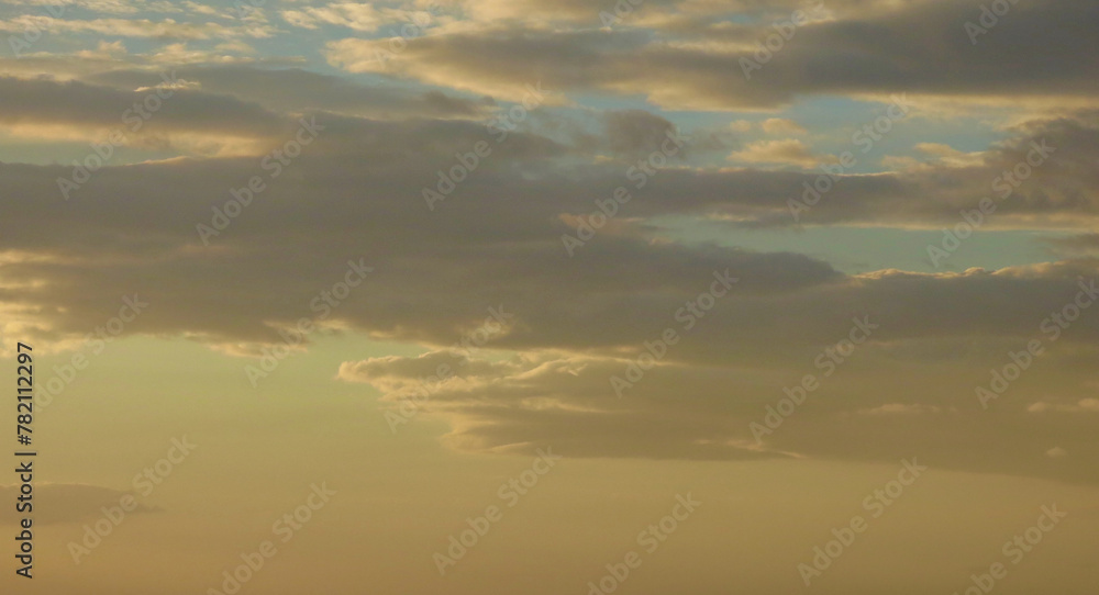 Fototapeta premium Clouds at sunset. View of orange colored clouds during sunset.