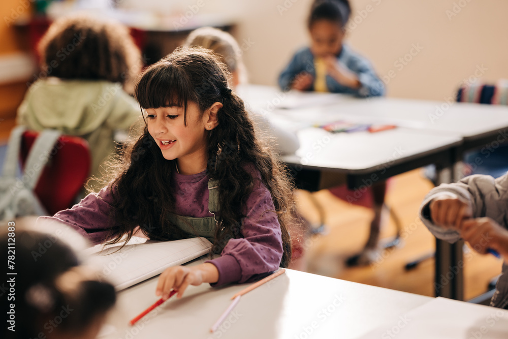 © Jacob Lund - Female elementary school student sitting at her desk and doing her school work © Jacob Lund - Female elementary school student sitting at her desk and doing her school work