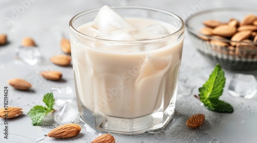 In a glass  almond milk with ice  the smooth  light beige refreshment a soothing respite on a warm day  embodying understated grace no splash