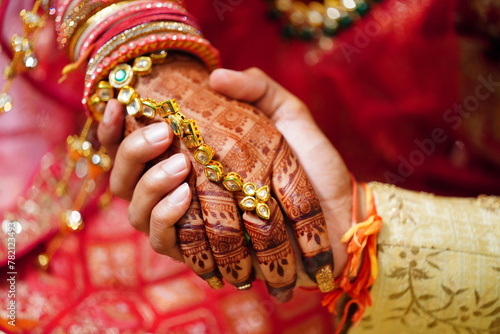 Mumbai, India 9th April 2024: Indian Wedding rituals, Customs and Traditions for bride or Dulhan. Pandit performing holy pooja. Shagun, Mehendi, and old customs. Couple holding hands during marriage photo