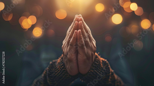 Praying hands with faith in religion and belief in God on dark background photo