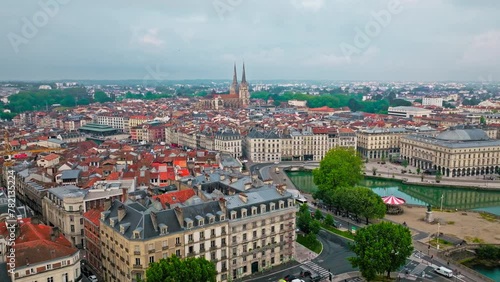 Aerial view of Bayonne city in Basque Country region by the river. Narrow medieval streets and red rooftop buildings. Twin towers rise from hilltop Gothic cathedral with medieval cloisters in France. photo