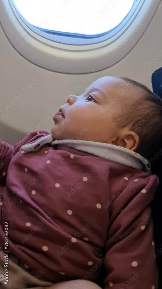 Mother and daughter sitting in an airplane Mother and daughter sitting in an airplane