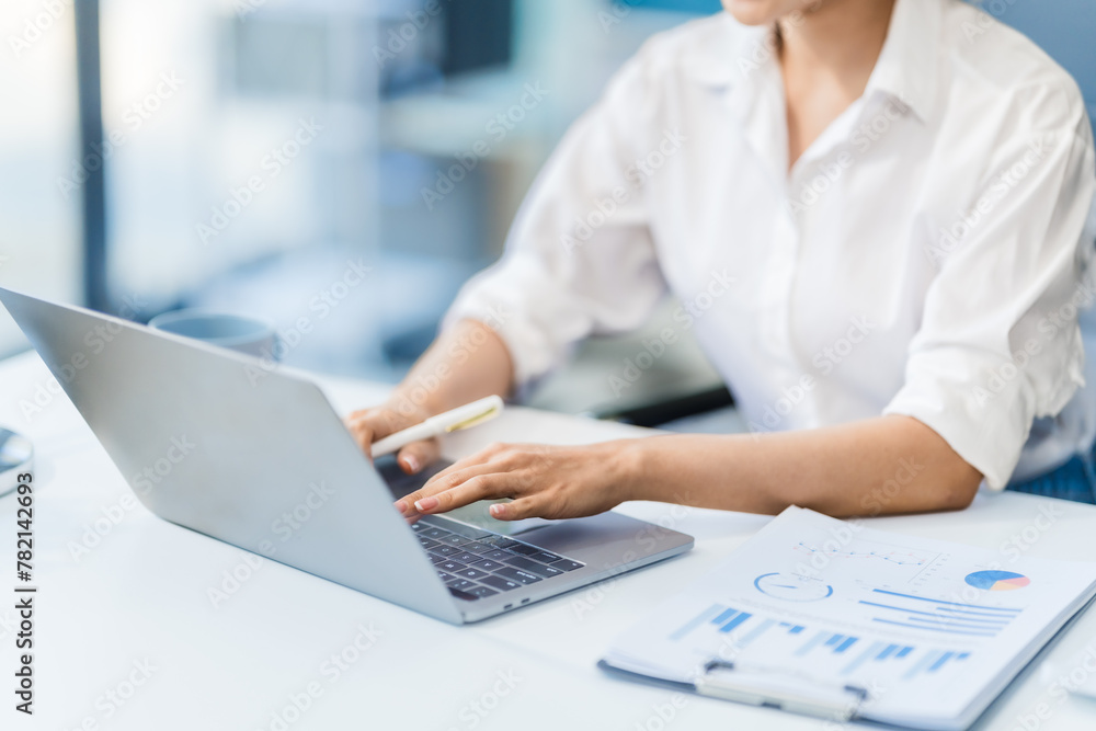 In the office, a businesswoman, accountant by profession, works on financial documents. She uses a computer to calculate income, analyze data, and manage budgets. Asian people. In the office, a businesswoman, accountant by profession, works on financial documents. She uses a computer to calculate income, analyze data, and manage budgets. Asian people.