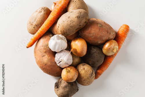 food, eating and culinary concept - close up of different raw vegetables on white background, top view