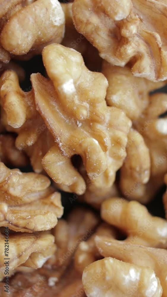 Walnut close up. Walnut kernels rotating. Rotating nuts background. Vertical video. Walnut close up. Walnut kernels rotating. Rotating nuts background. Vertical video.