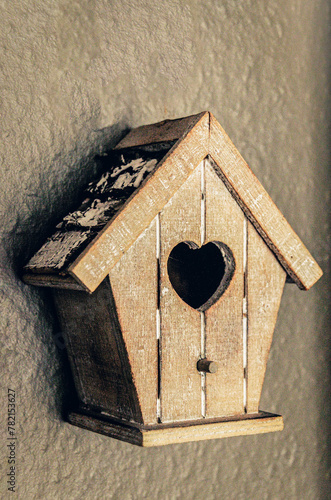 handmade decorative wooden birdhouse on the wall © Monika