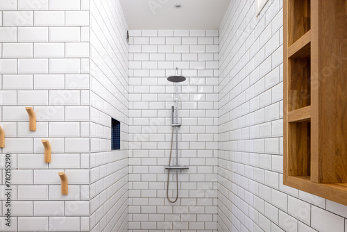 Interior of a modern home in The Netherlands. Rain shower and white tiles in the bath room.
